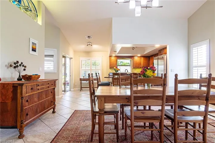 Dining area featuring light tile patterned floors and baseboards