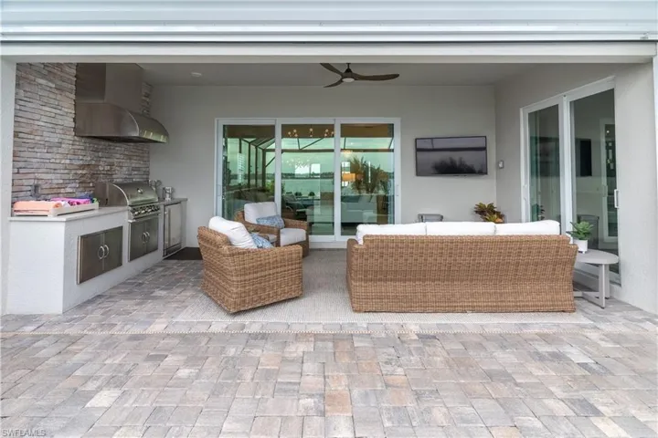 View of patio featuring a grill, area for grilling, an outdoor hangout area, and ceiling fan