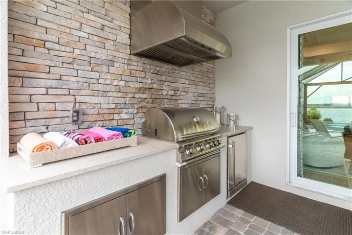 Kitchen featuring high quality fridge and range hood
