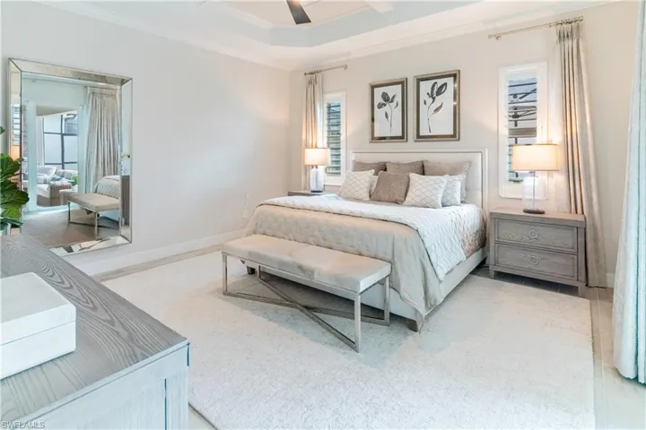 Bedroom with ornamental molding and ceiling fan
