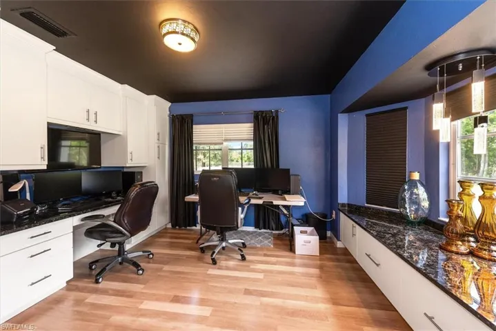 Office featuring light wood-type flooring, plenty of natural light, and built in study area