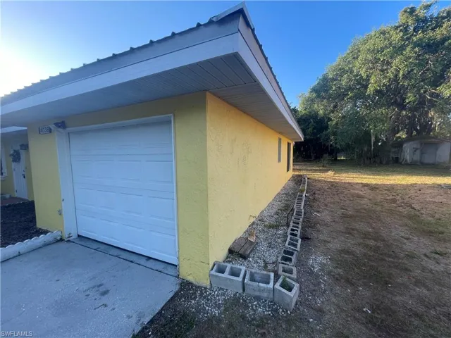 View of property exterior featuring a garage and stucco siding