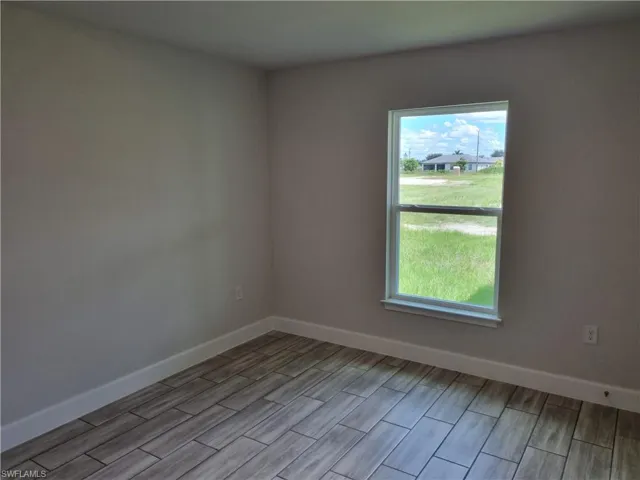 Empty room with light hardwood / wood-style flooring
