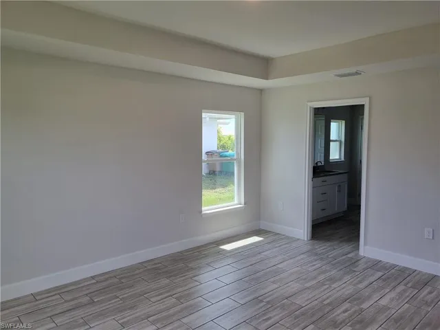 Spare room featuring sink and light hardwood / wood-style flooring