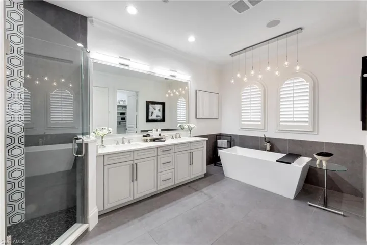 Primary bathroom, updated tile, rain shower, soaking tub, double vanity