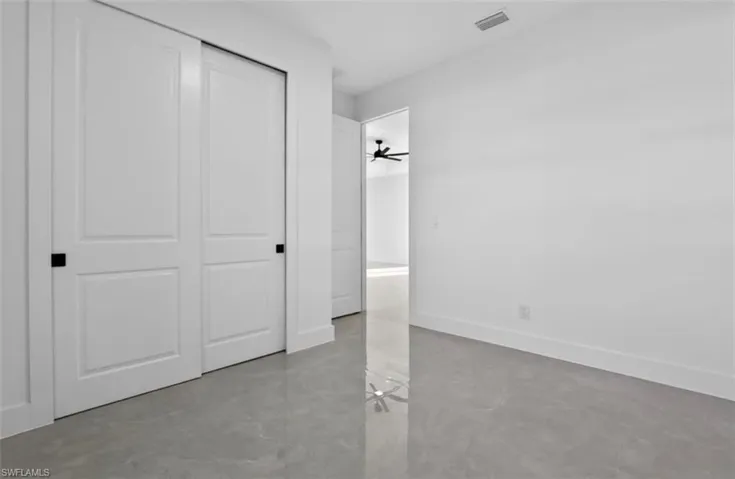 Unfurnished bedroom featuring baseboards and a closet