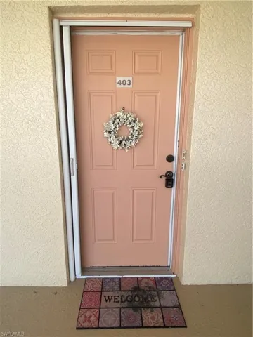 Property entrance featuring stucco siding