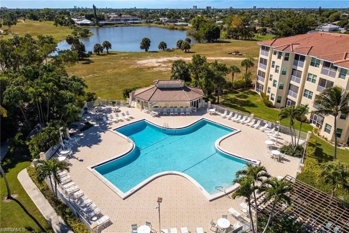 Community pool with a patio area and a water view
