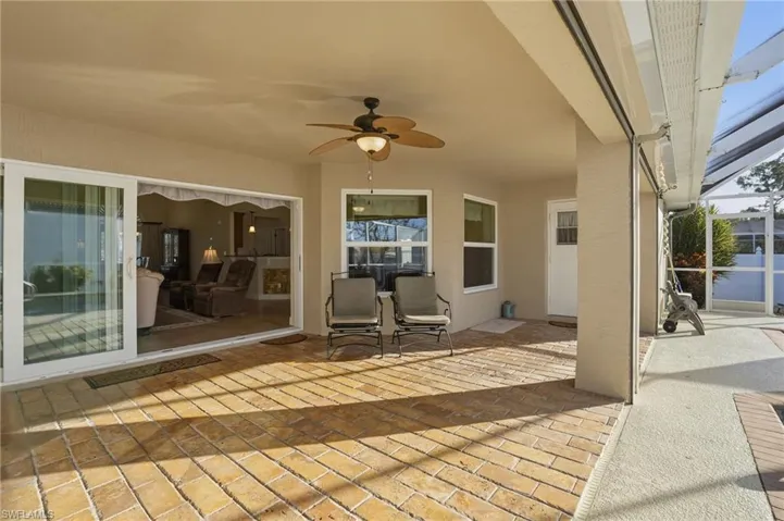View of patio featuring a lanai, ceiling fan, and a sunroom