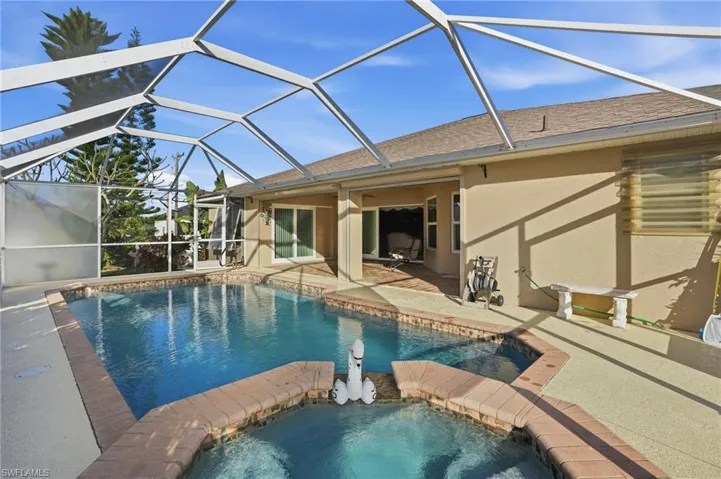 View of swimming pool with a sunroom, a patio, a lanai, and a pool with connected hot tub