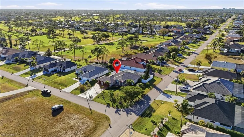 Aerial view of property's location featuring nearby suburban area and a golf club