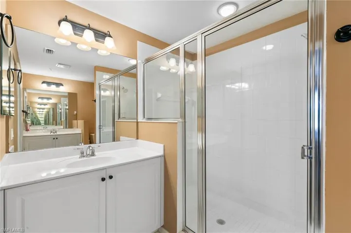 Bathroom featuring an enclosed shower and vanity