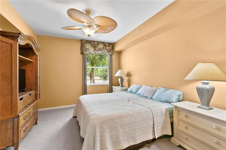 Bedroom with ceiling fan and carpet floors