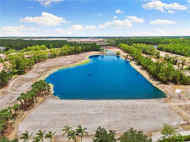 Birds eye view of property with a water view