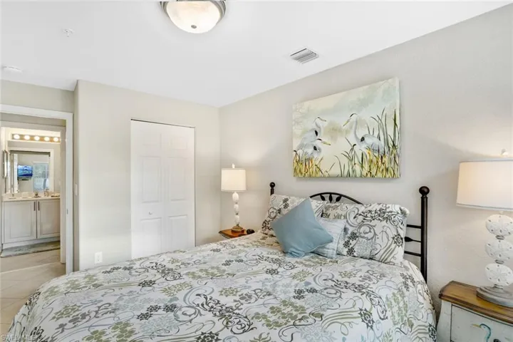 Tiled bedroom featuring ensuite bath