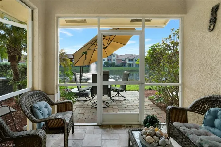 Sunroom / solarium with outdoor dining area and a water view