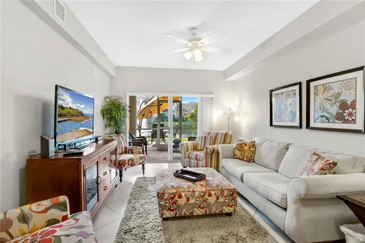 Living room featuring ceiling fan and light tile patterned floors