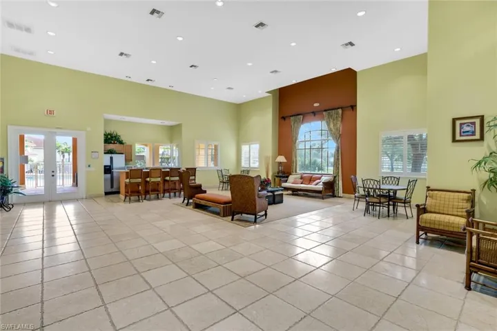 Building lobby featuring a towering ceiling and recessed lighting