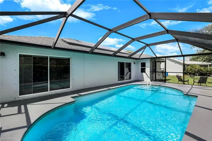 Outdoor pool featuring a patio, a sunroom, and a lanai