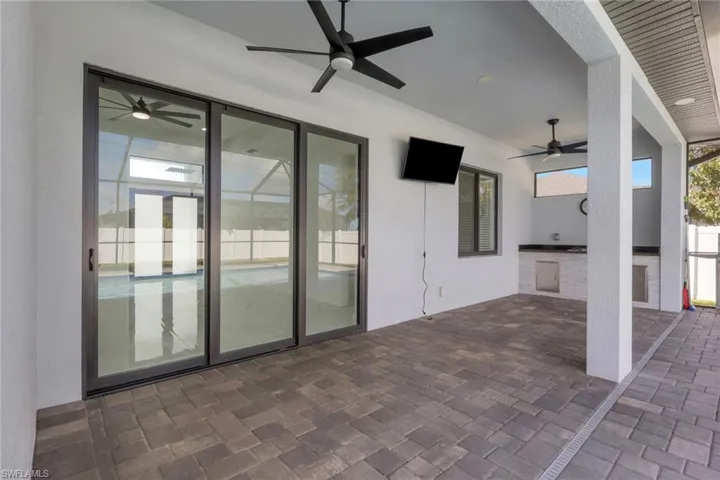 View of patio / terrace featuring area for grilling and ceiling fan