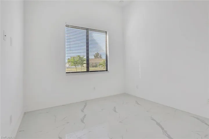 Empty room with marble look tile flooring