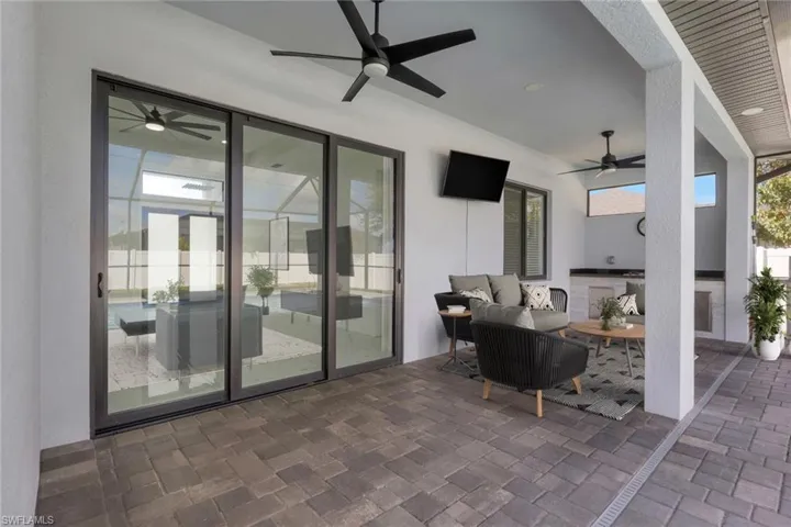 View of patio / terrace with a ceiling fan and an outdoor kitchen and area to lounge