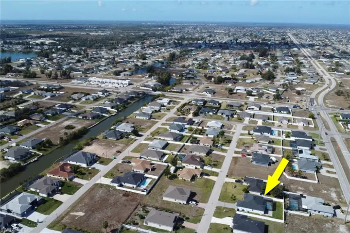 Aerial view of property's location featuring nearby suburban area