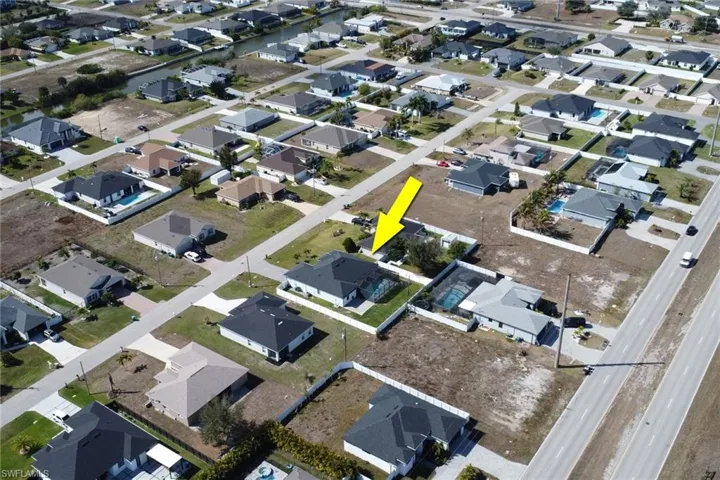 Aerial view of property's location featuring nearby suburban area