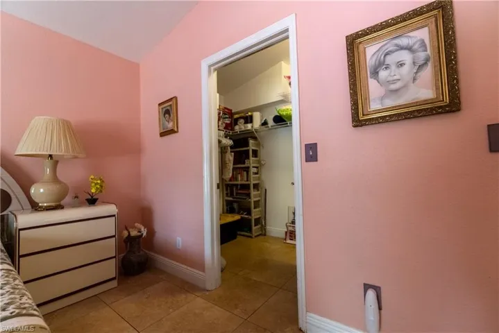 Hall with baseboards and light tile patterned floors
