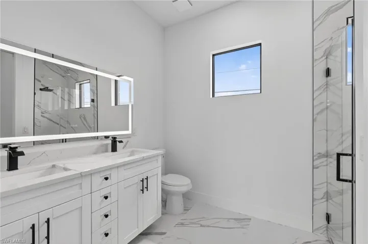 Primary bathroom vanity and toilet