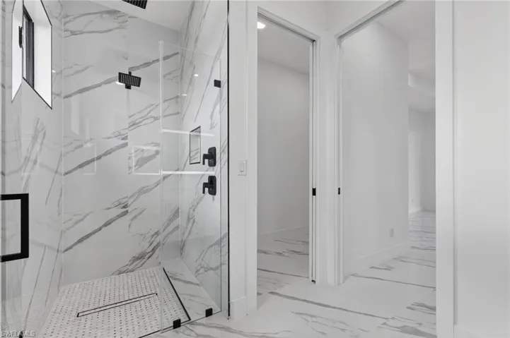 Primary bathroom shower and walk-in closet