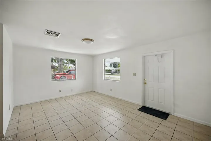 Unfurnished room featuring light tile patterned floors and baseboards