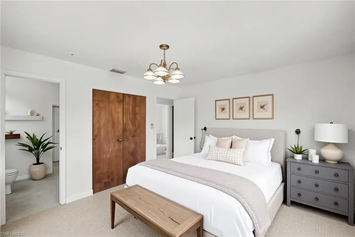Bedroom with a chandelier, tile flooring, a closet and ensuite bathroom