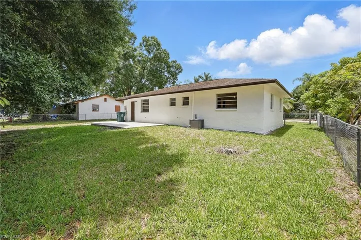 Rear view of property with stucco siding, a patio, and central air condition unit