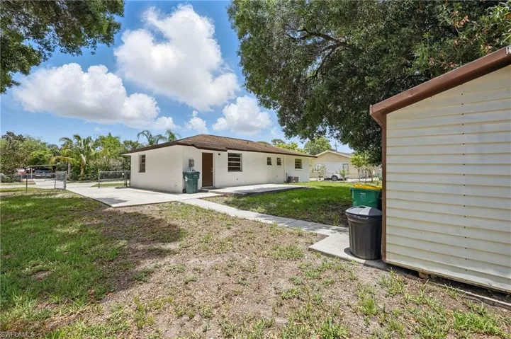 Rear view of house with a patio and shed