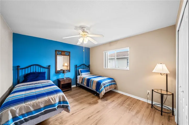 Bedroom with wood finished floors, baseboards, and ceiling fan