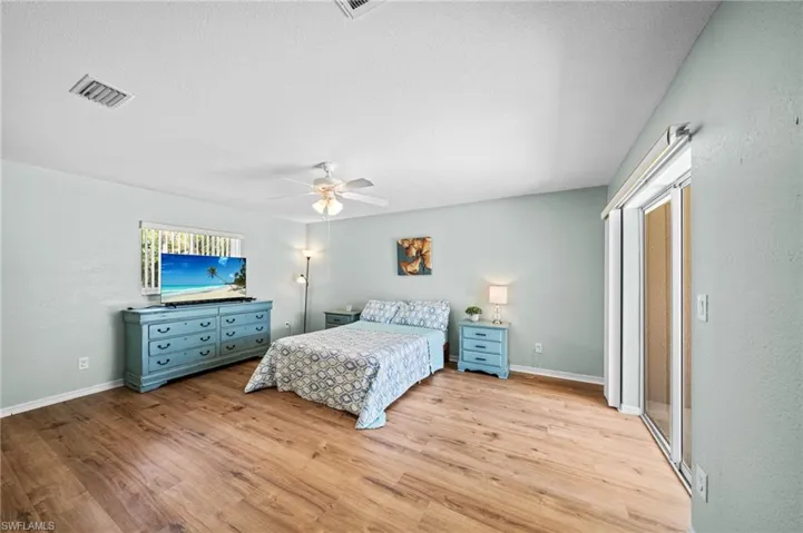 Bedroom featuring light wood-type flooring, baseboards, and a ceiling fan
