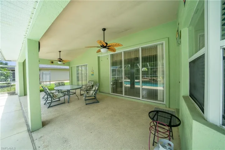 View of patio with outdoor dining space and ceiling fan