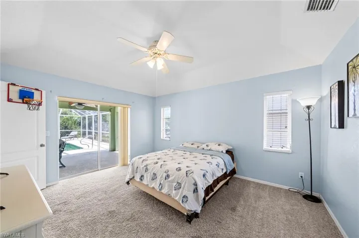 Bedroom featuring access to outside, carpet flooring, baseboards, and a ceiling fan