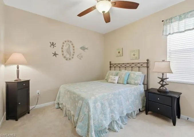 Bedroom featuring light carpet and a ceiling fan