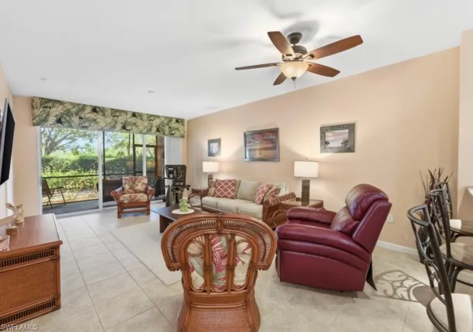 Living area with light tile patterned floors and ceiling fan