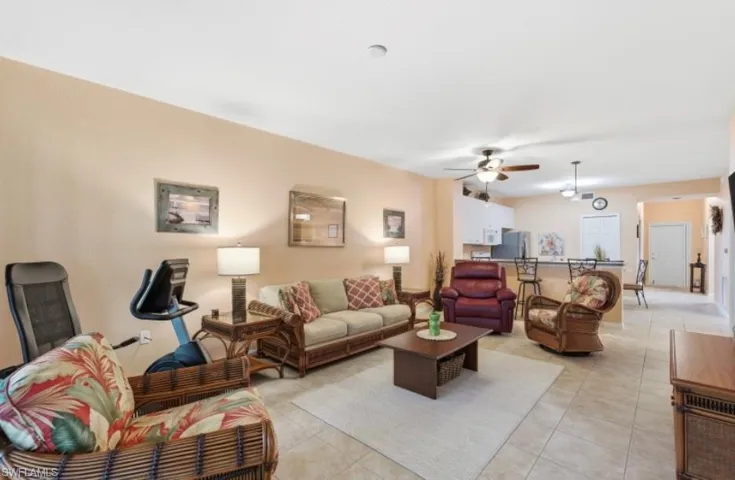 Living room featuring light tile patterned flooring and a ceiling fan