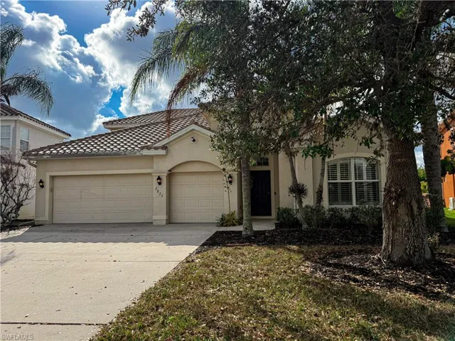 Mediterranean / spanish-style home with a garage, stucco siding, concrete driveway, and a tiled roof