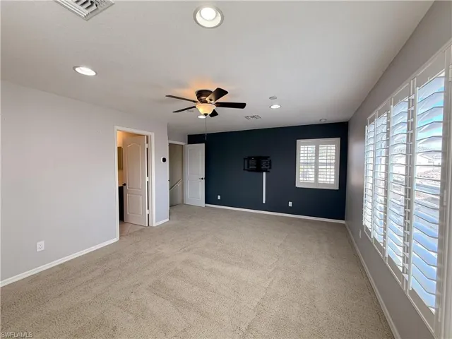 Unfurnished room featuring light carpet, ceiling fan, and recessed lighting