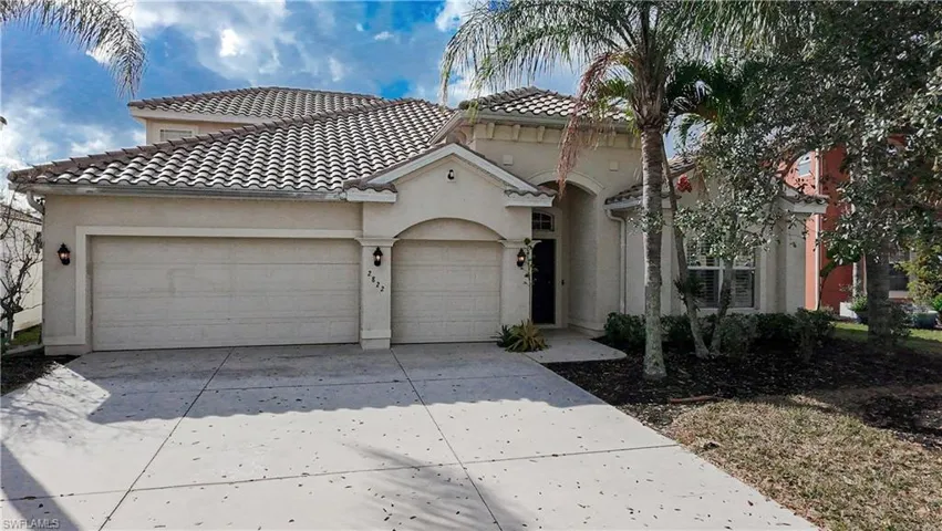 Mediterranean / spanish-style home featuring a garage, driveway, stucco siding, and a tiled roof