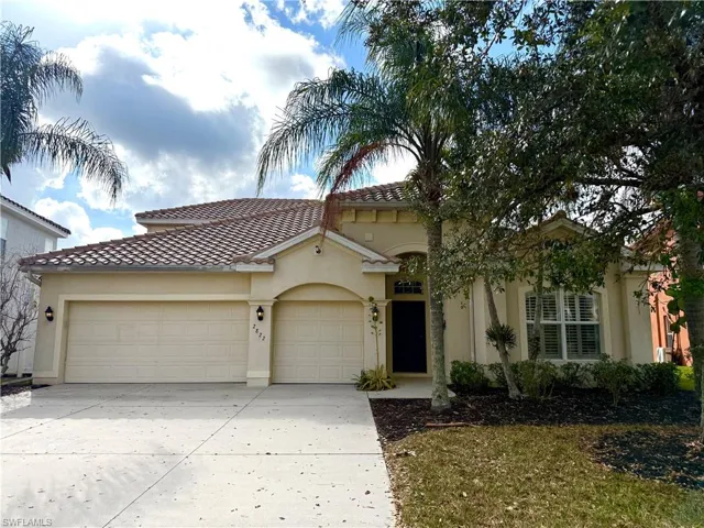Mediterranean / spanish-style home featuring a garage, concrete driveway, stucco siding, and a tile roof