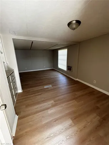 Spare room with light wood-style flooring and baseboards
