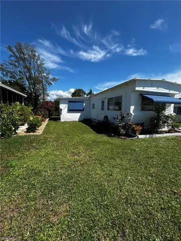 View of side of home with a lawn