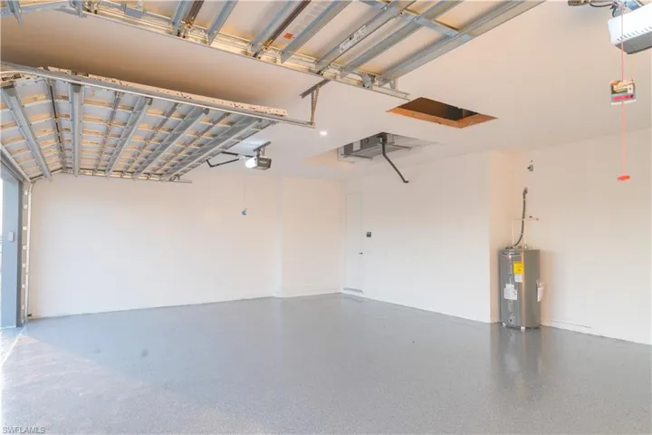 Garage with electric water heater and a garage door opener