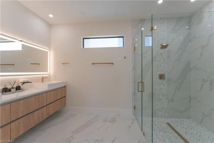 Bathroom featuring vanity and a shower with shower door